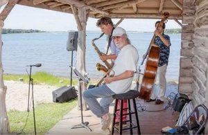 Band playing on stage by water